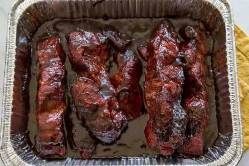 smoked country style ribs in an aluminum pan