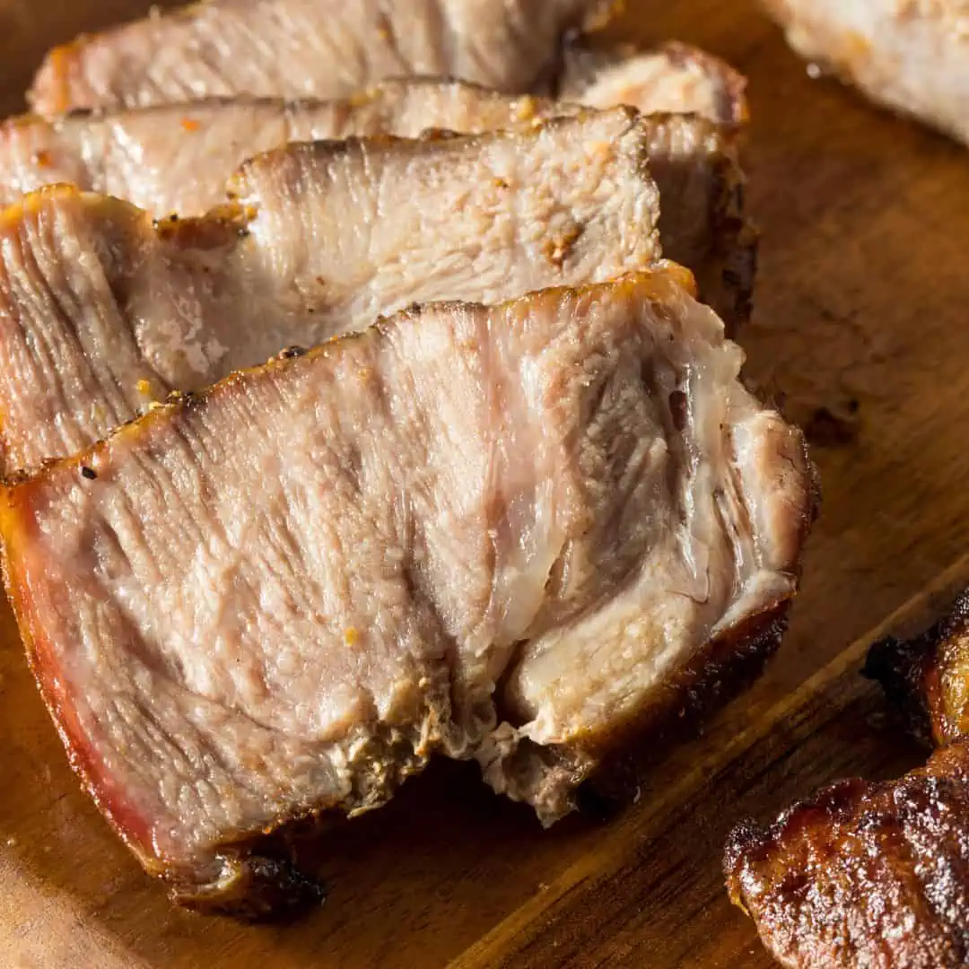 sliced pork butt on a cutting board