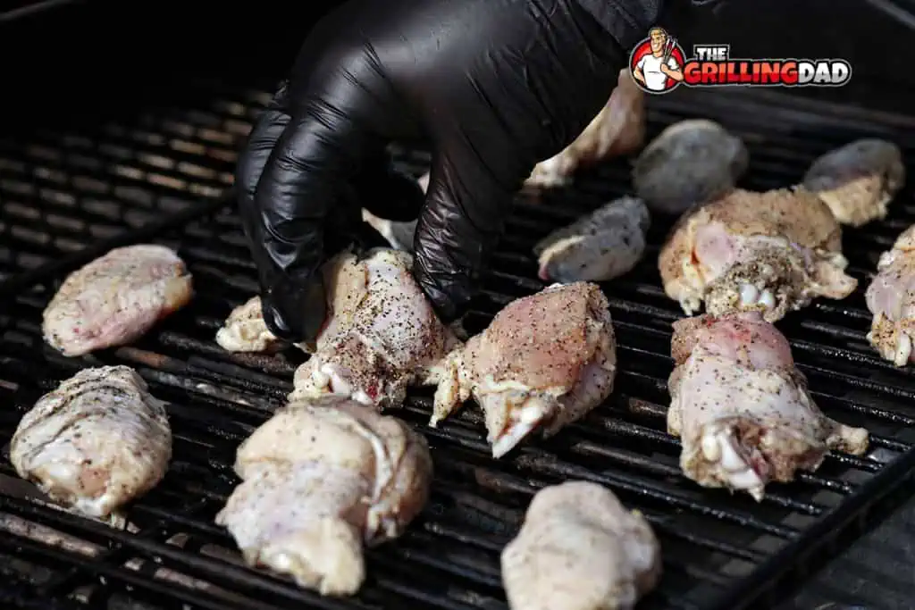 putting the chicken wings on the smoker